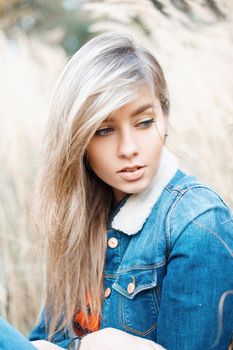 Close-up portrait of a beautiful ????? in a denim jacket