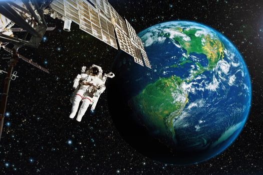 Astronaut in outer space against the backdrop of the planet earth. Elements of this image furnished by NASA.