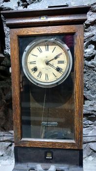 Kiruna, Sweden, February 22, 2020. An ancient grandfather clock resting on a wall