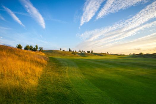 On the empty golf course at sunset.