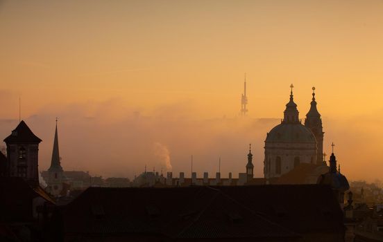 The Church of Saint Nicholas in the morning mist. The Church of Saint Nicholas is a Baroque church in the Lesser Town of Prague.