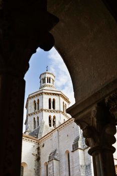 Beautiful bell tower of Cistercian abbey of Fossanova -Italy - in the foreground part of columns of the cloister