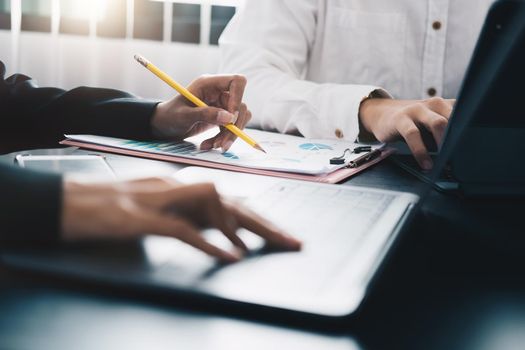 Business People Meeting to analyse and discuss and brainstorming the financial report chart data in office Financial advisor teamwork concept.