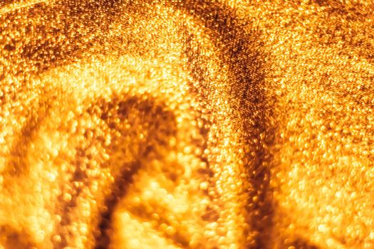 Luxe glowing texture, night club branding and New Years party concept - Golden holiday sparkling glitter abstract background, luxury shiny fabric material for glamour design and festive invitation