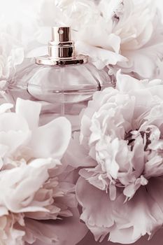 Chic fragrance bottle as luxe perfume product on background of peony flowers, parfum ad and beauty branding design