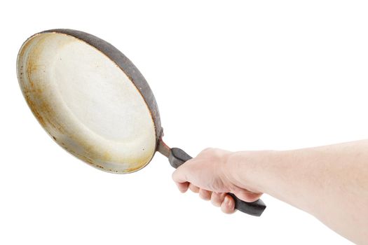 bare caucasian hand holding empty old aluminium frying pan.
