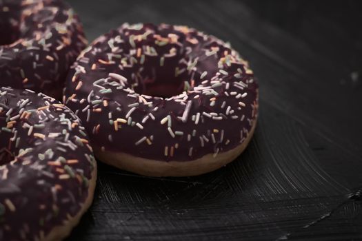 Bakery, branding and cafe concept - Frosted sprinkled donuts, sweet pastry dessert on rustic wooden background, doughnuts as tasty snack, top view food brand flat lay for blog, menu or cookbook design