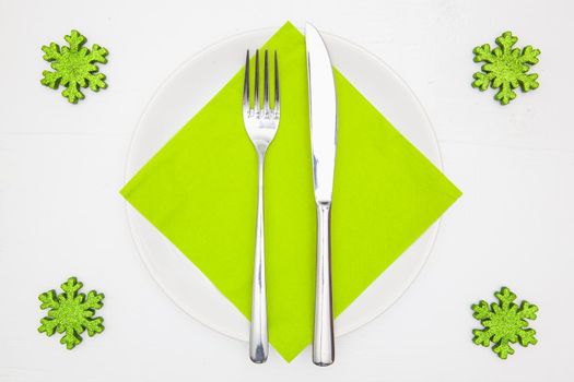 White square plate and green Christmas decoration on the white  wooden table.Top view.Flat Lay Image.