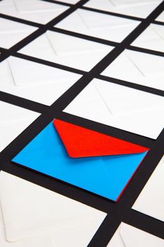 Composition with white and two-color envelopes on the table. The photo suitable for various holidays and anniversaries.