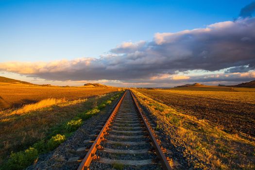 Single railway track at sunset, Central Bohemian Uplands, Czech Republic. Railway track in nature park Central Bohemian Highlands, Czech Republic