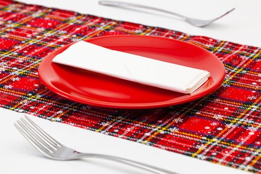 Red plate and Christmas decoration on the white wooden table.Top view. Flat Lay Image.