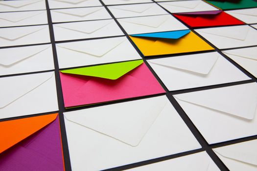 Composition with white and colored envelopes on the table. The photo suitable for various holidays and anniversaries.