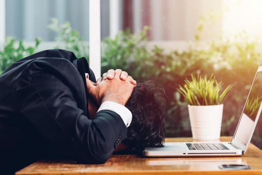 Business man unhappy head down on laptop computer on desk office