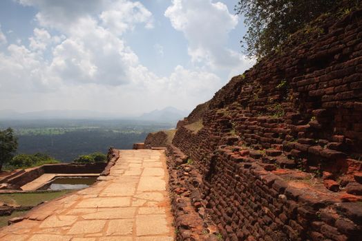 Ruins on top of Sigiriya Lion's rock palace and fortress.Sri Lanka. The name refers to a site of historical and archaeological significance that is dominated by a massive column of rock nearly 200 metres high.
