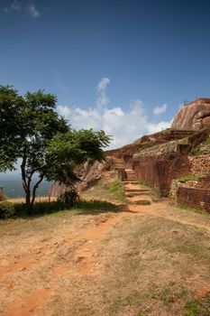 Ruins on top of Sigiriya Lion's rock palace and fortress.Sri Lanka. The name refers to a site of historical and archaeological significance that is dominated by a massive column of rock nearly 200 metres high.