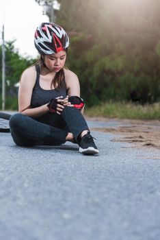 Beautiful young female woman pain injured accident sitting after bicycle falling with copy space