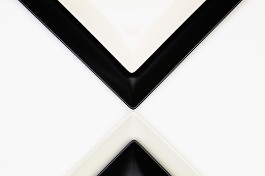 Different  black and white plates on the white table.Top view. Flat Lay Image.