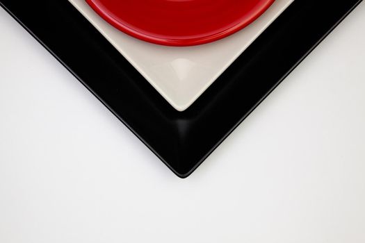 Different  red, black and plates on the white table.Top view. Flat Lay Image.