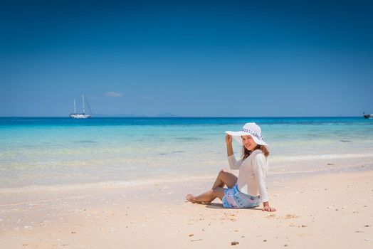 Happy young woman enjoying on beach relaxing summer at Thailand