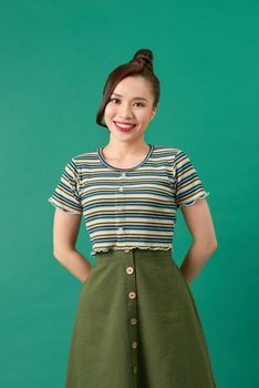 Smiling young woman over green