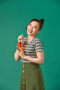 Portrait of a woman drinking orange juice. Orange juice in glass