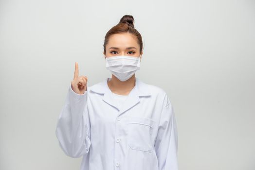 Young doctor woman showing and lifting a finger in sign of the best