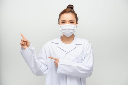 Portrait of an attractive young female doctor in white coat