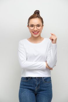 Simple portrait of an asian girl with arms crossed on white background.