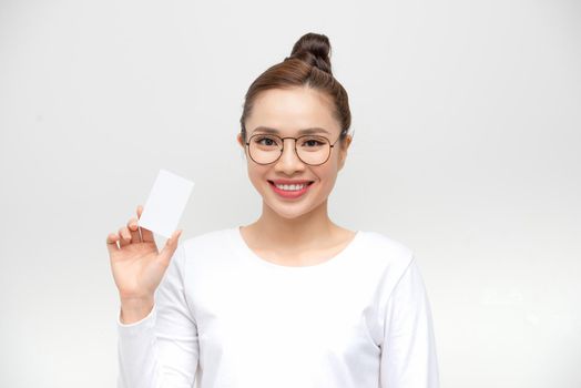 Young Asian woman point to a blank card on white background