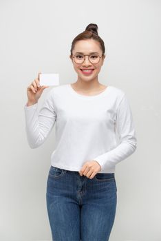 Young smiling woman show blank card. Girl portrait isolated on white background.
