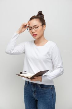 Portrait of an attractive thought sexy woman. Holds an open notebook and pen, thoughtfully with close eyes