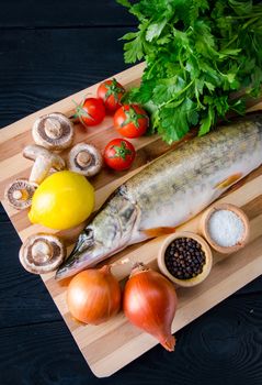 Uncooked fish on cutting board in meal preparation concept