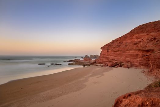 Landscape of Legzira Beach with its natural arches at the coast of Atlantic ocean. Legzira Beach is located on the ocean coast of Morocco, in Sidi Ifni, close to Agadir.