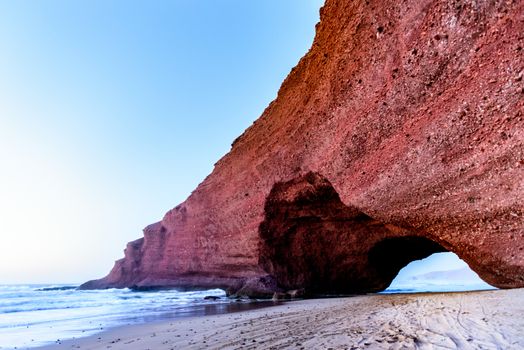Landscape of Legzira Beach with its natural arches at the coast of Atlantic ocean. Legzira Beach is located on the ocean coast of Morocco, in Sidi Ifni, close to Agadir.