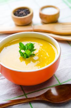 Pumpkin soup served on the table in bowl