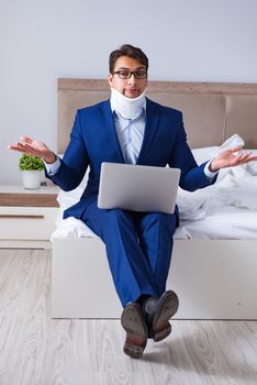 Businessman with neck injury working from home