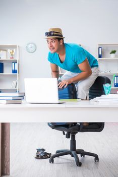 Businessman preparing for vacation in the office
