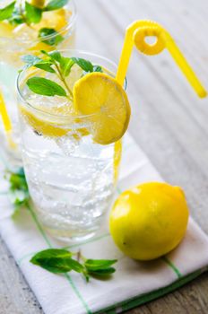 Glasss of mojito with lemon and drinking straw