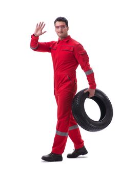 Young tyre repairman in red coveralls isolated on white background