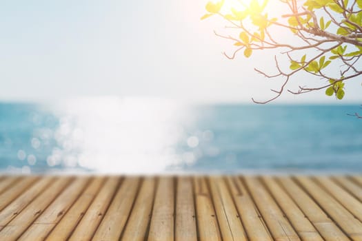 Selective focus of old wood table with blur beautiful beach for display your product.