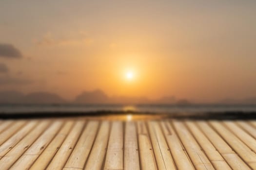 Selective focus of old wood table with blur beautiful beach for display your product.