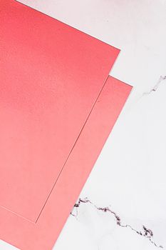 Pink A4 papers on white marble background as office stationery flatlay, luxury branding flat lay and brand identity design for mockups