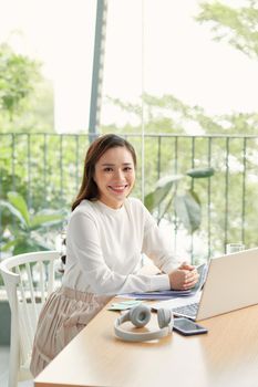 Portrait of Asia Business woman sitting at desk and working with laptop Notebook and computer.