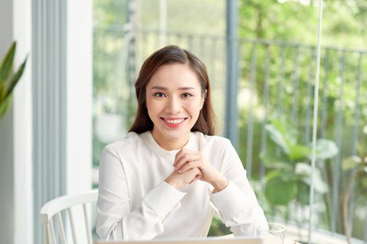 Young beautiful woman at home with crossed arms confident and happy with a big natural smile laughing