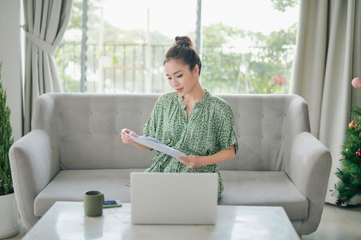 Stay home concept. Pretty lady home alone quarantine time watch notebook video talk relatives friends distance work remote sit comfortable sofa living room indoors