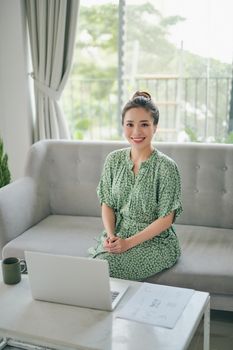 Asian woman made meeting online by using laptop.