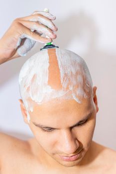 Man Shaving His Head Using White Foam