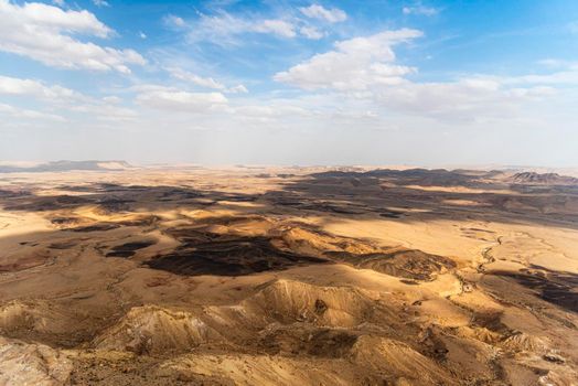 Ramon Crater Makhtesh Ramon, the largest in the world, as seen from the high rocky cliff edge surrounding it from the north, Ramon Nature reserve, Mitzpe Ramon, Negev desert, Israel. High quality photo