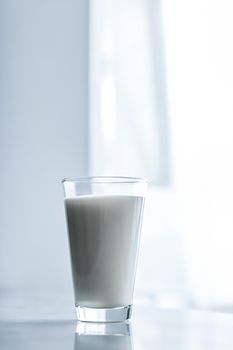 Dairy, healthy nutrition and breakfast concept - World Milk Day, full glass on marble table