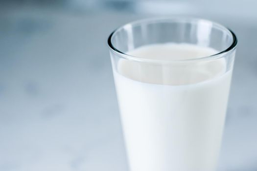 Dairy, healthy nutrition and breakfast concept - World Milk Day, full glass on marble table